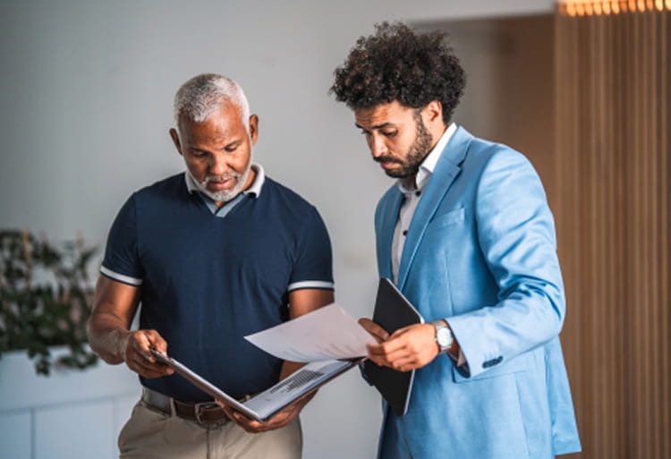 Two men reviewing documents together in office